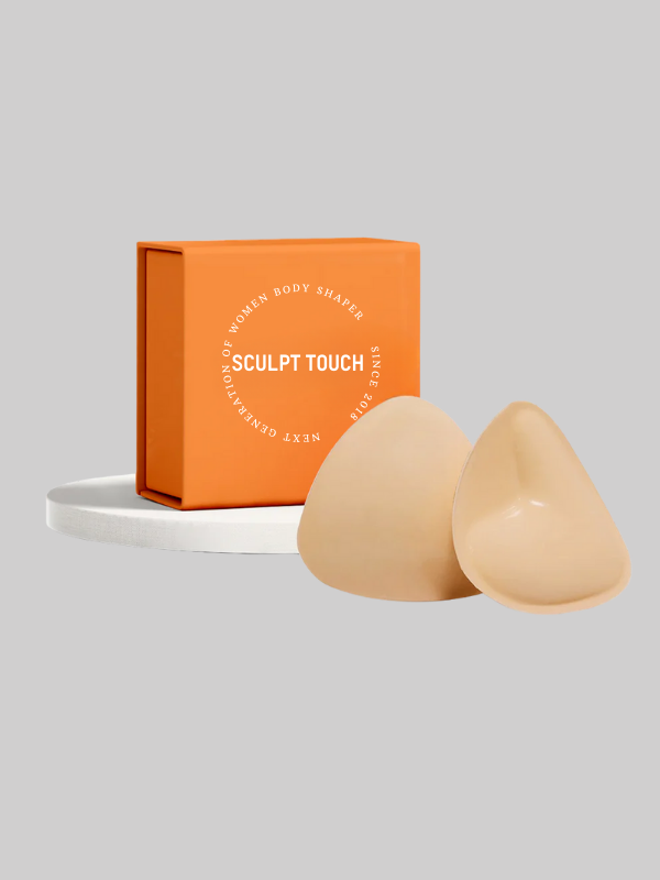 Nude-colored padded sticky inserts with Sculpt Touch packaging box for breast lift and cleavage enhancement.