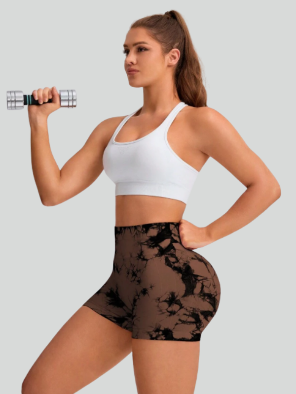 Athleisure look with black and brown tie-dye shorts and sneakers for yoga or gym