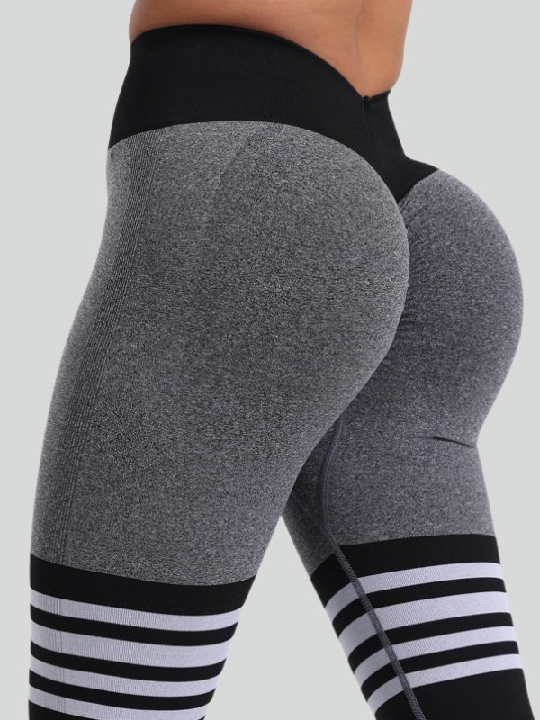 Stretchy spandex yoga pants featuring high-rise waistband and hip-lifting silhouette for enhanced body curves.