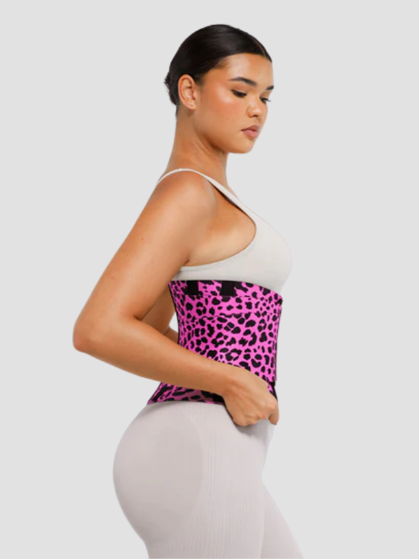 Side view of woman wearing SCULPT TOUCH pink leopard print waist trainer, highlighting slim fit and body-contouring support.