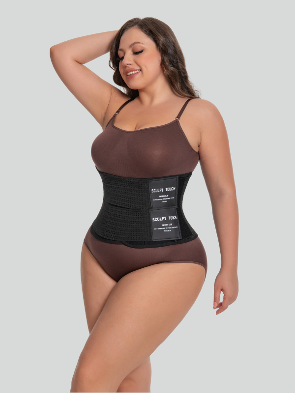 Angled side view of black breathable waist trainer worn by model, demonstrating flexibility and all-day support.