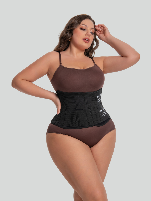 Side view of model in black mesh waist trainer showing strong waist compression and comfortable fit.