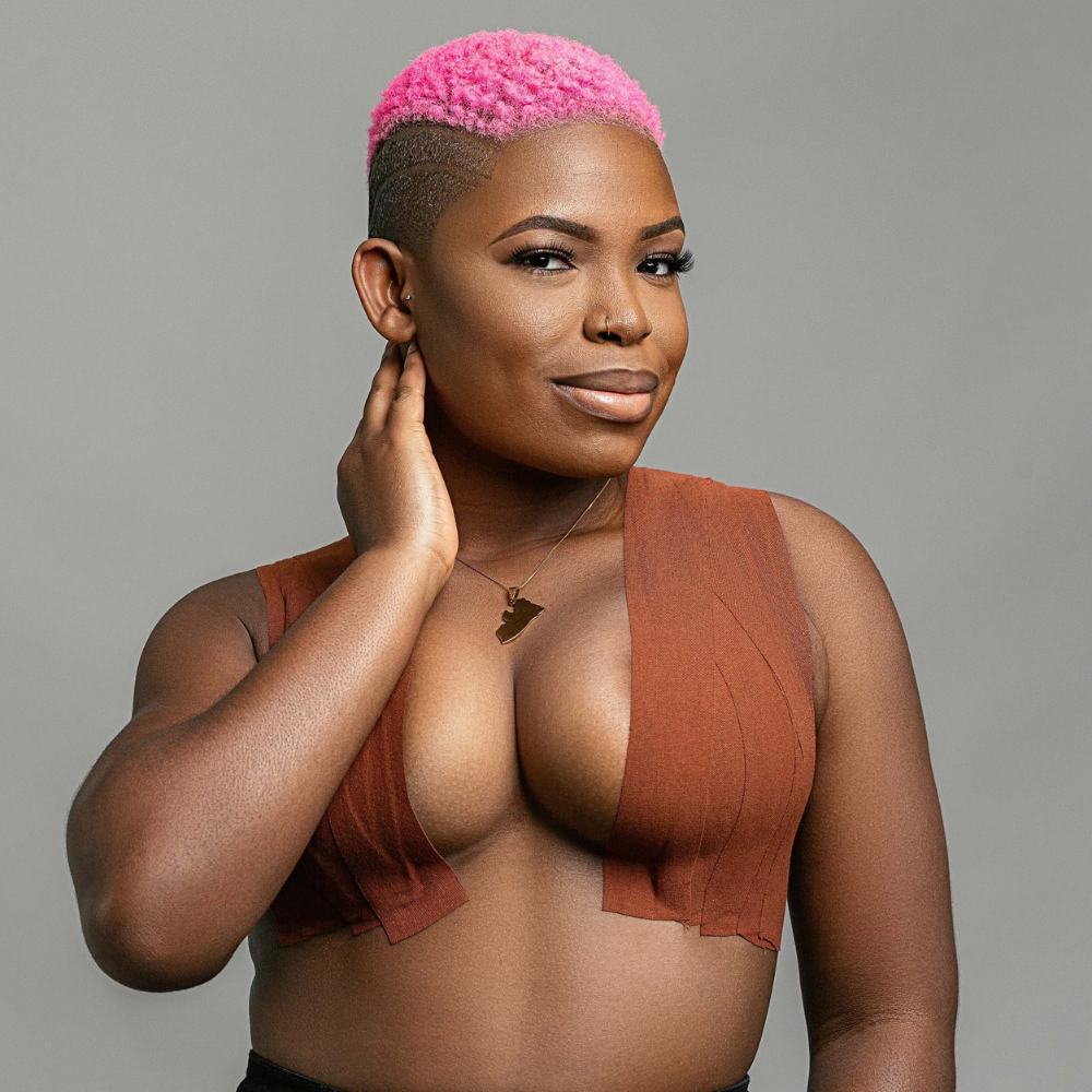 Model applying Secret Breast Tape for natural lift and support under a strapless outfit.