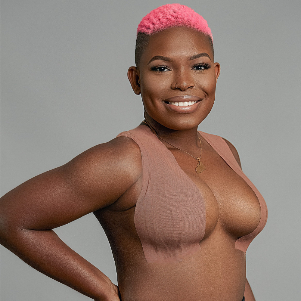 Smiling model wearing strapless dress confidently using Secret Breast Tape for invisible support.