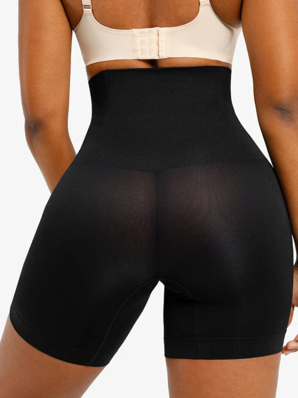 Back view of model wearing sculpting shorts highlighting enhanced curves and breathable fabric.