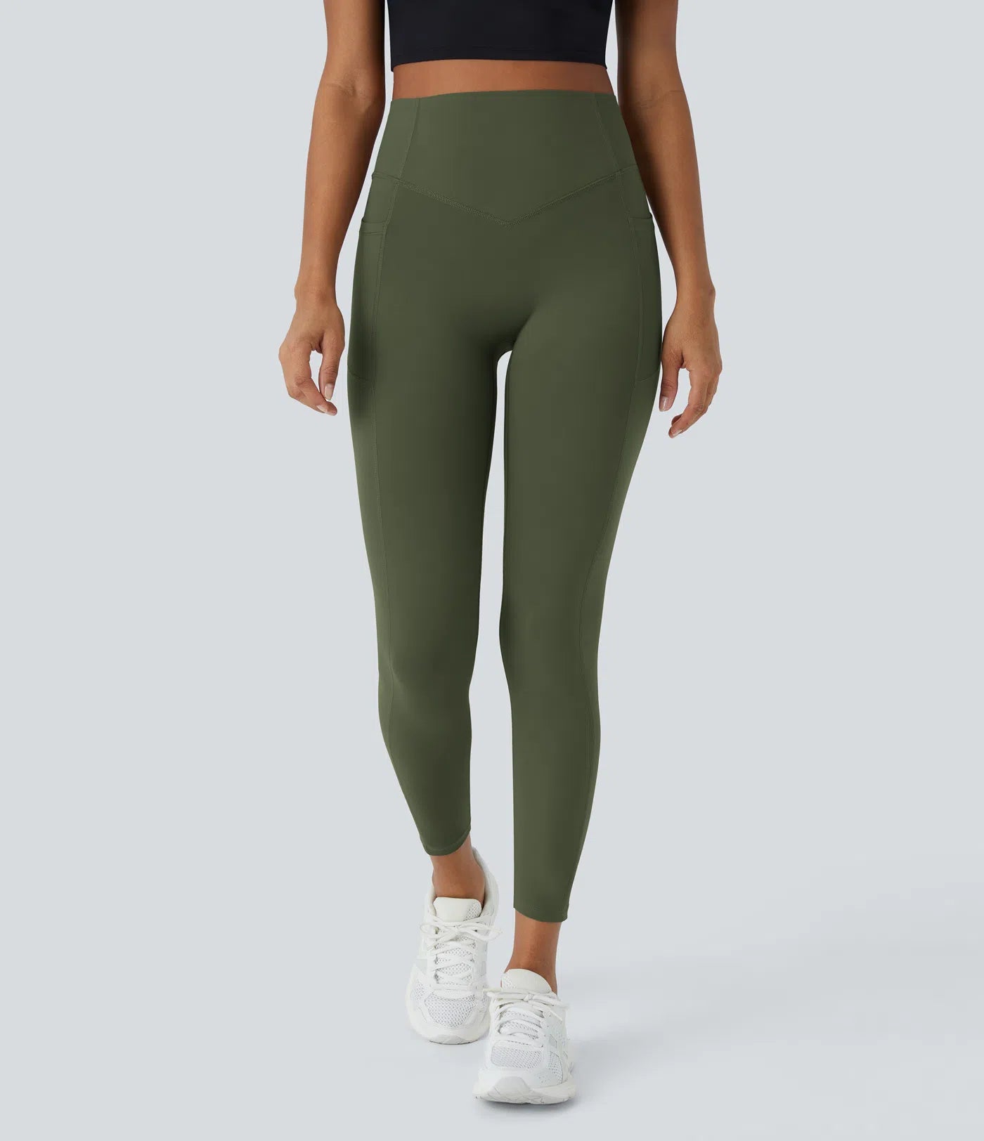Model wearing olive green BBL leggings showcasing stretchy, breathable fabric and snug fit for active workouts.