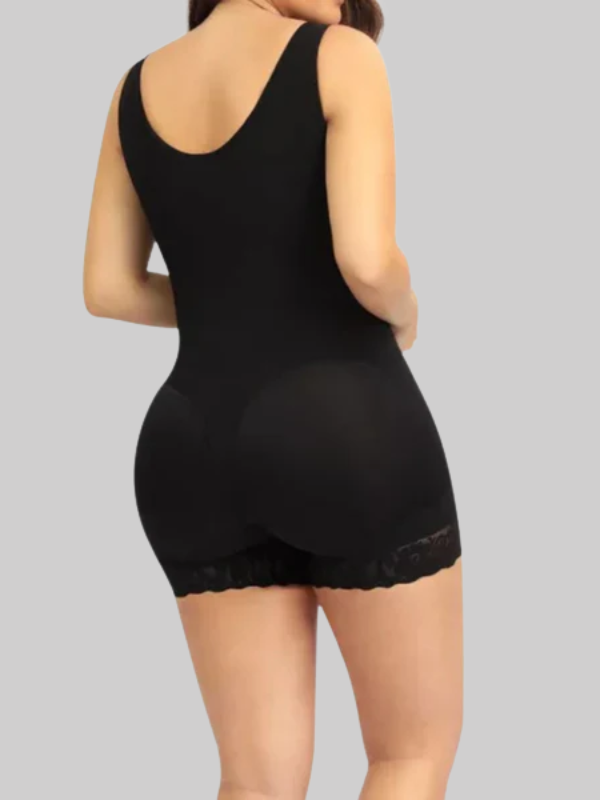 Angled side view showing breathable powernet material and open gusset design of black faja worn by model.