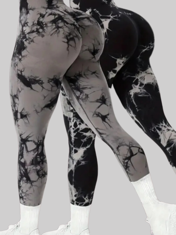 Two women wearing seamless scrunch butt leggings in gray and black lightning tie-dye pattern, showcasing a high-waisted, body-sculpting fit.