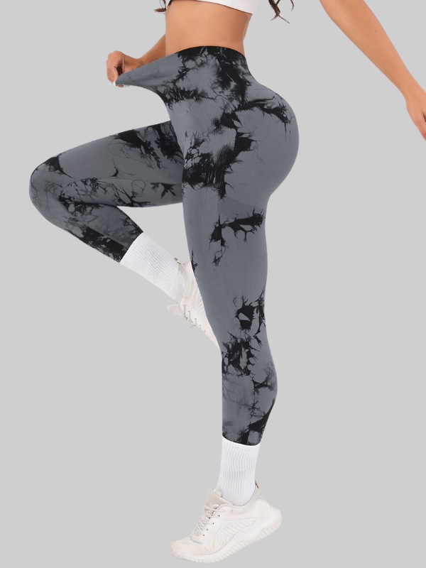 Woman posing in high waist seamless tie-dye leggings with scrunch butt and cropped fit, designed for gym, yoga, or casual activewear.