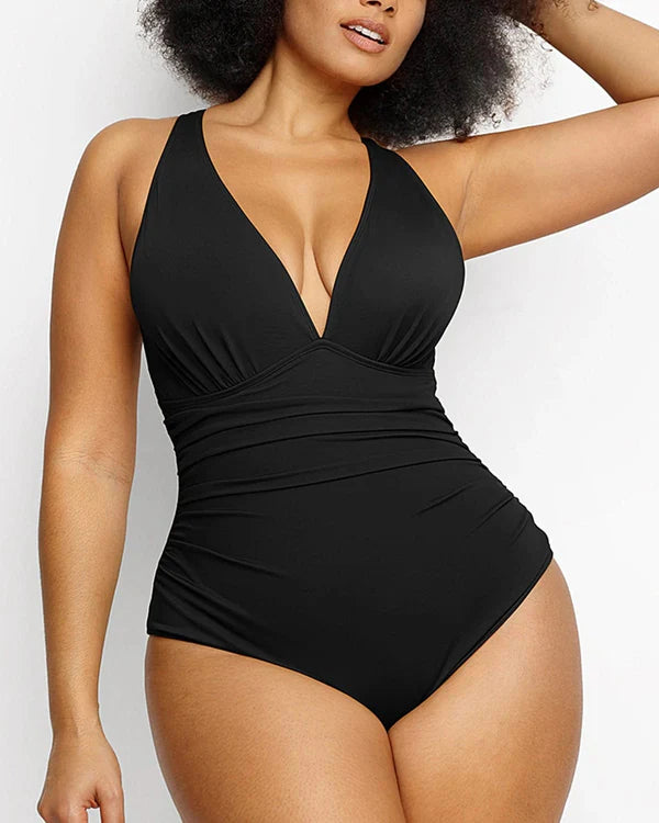 Model wearing Smart Sculpt black plunge cutout swimsuit with ruched waist