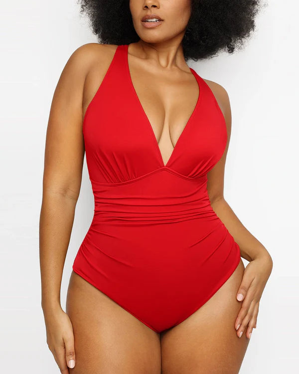 Front view of model wearing red Smart Sculpt plunge cutout swimsuit with ruched waist and deep V neckline for a flattering silhouette.