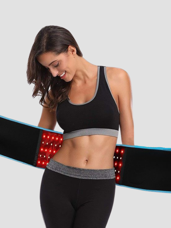 Smiling woman wearing a red light therapy belt around her waist, showing LED activation for abdominal treatment.