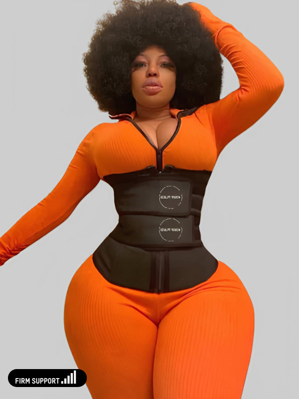 Woman in an orange jumpsuit wearing a black Double Snatch waist trainer for firm support.