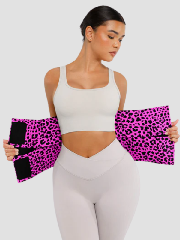 Female model adjusting SCULPT TOUCH pink leopard print waist trainer with triple wrap design for enhanced tummy compression and body contouring.