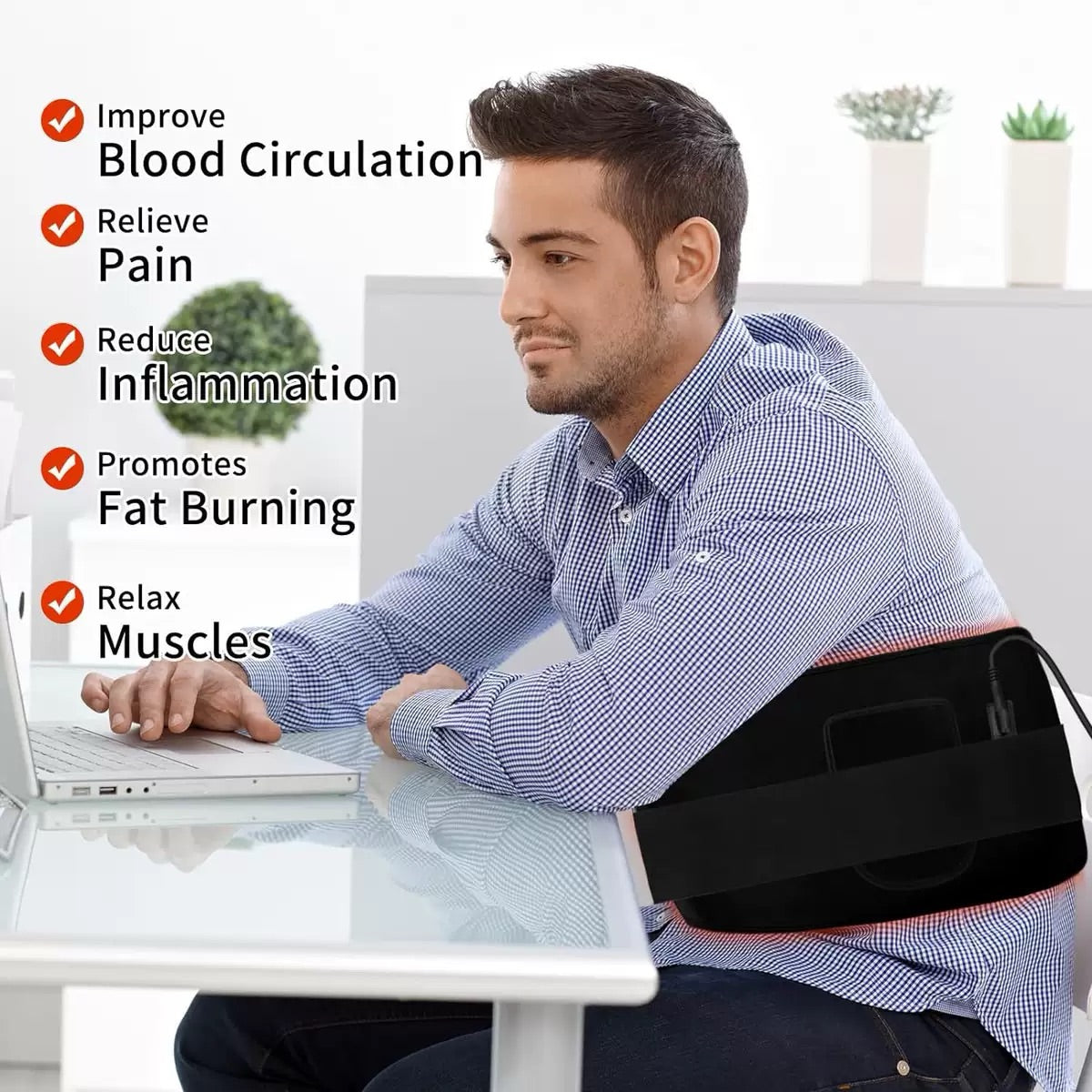 Man using red light therapy belt while working at a desk,  pain relief, improved circulation, fat burning, and muscle relaxation.
